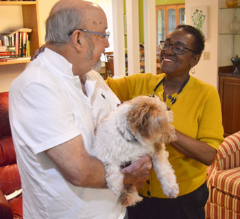 Cynthia with partner, Eric, and their dog. Thumbnail